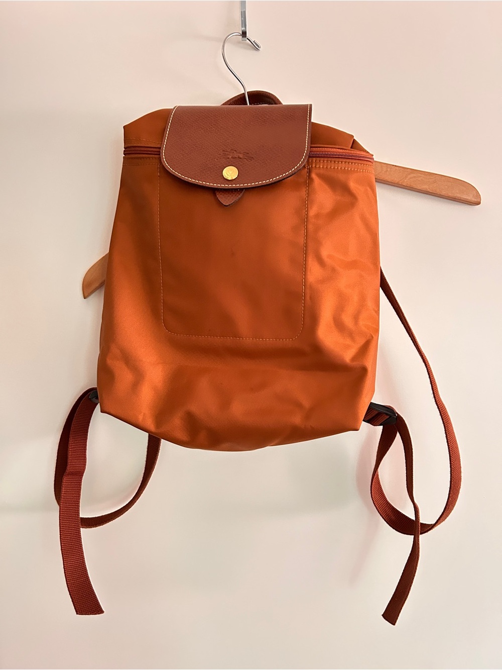 Longchamp nylon backpack in rust with brown leather flap